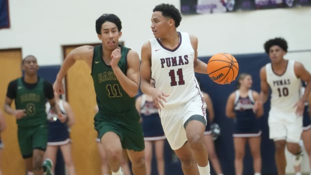 Arizona high school basketball: Perry Pumas guard No No Brown (11) brings the ball upcourt against the Basha Bears at Perry High School.